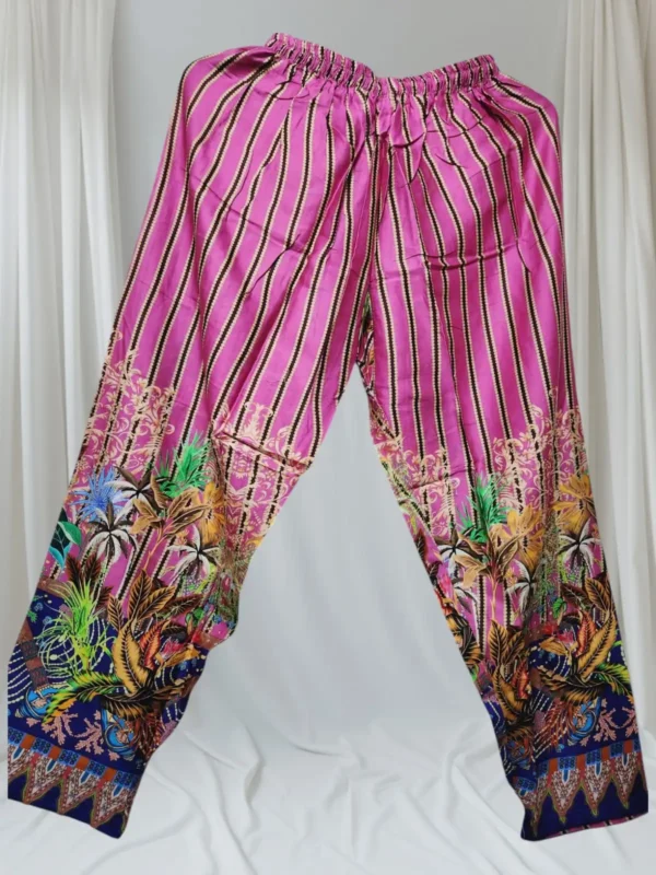 A black and white robe hanging on a clothes hanger, featuring a detailed pattern, displayed indoors.